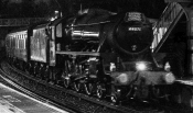 The steam engine passing on a dark wet evening